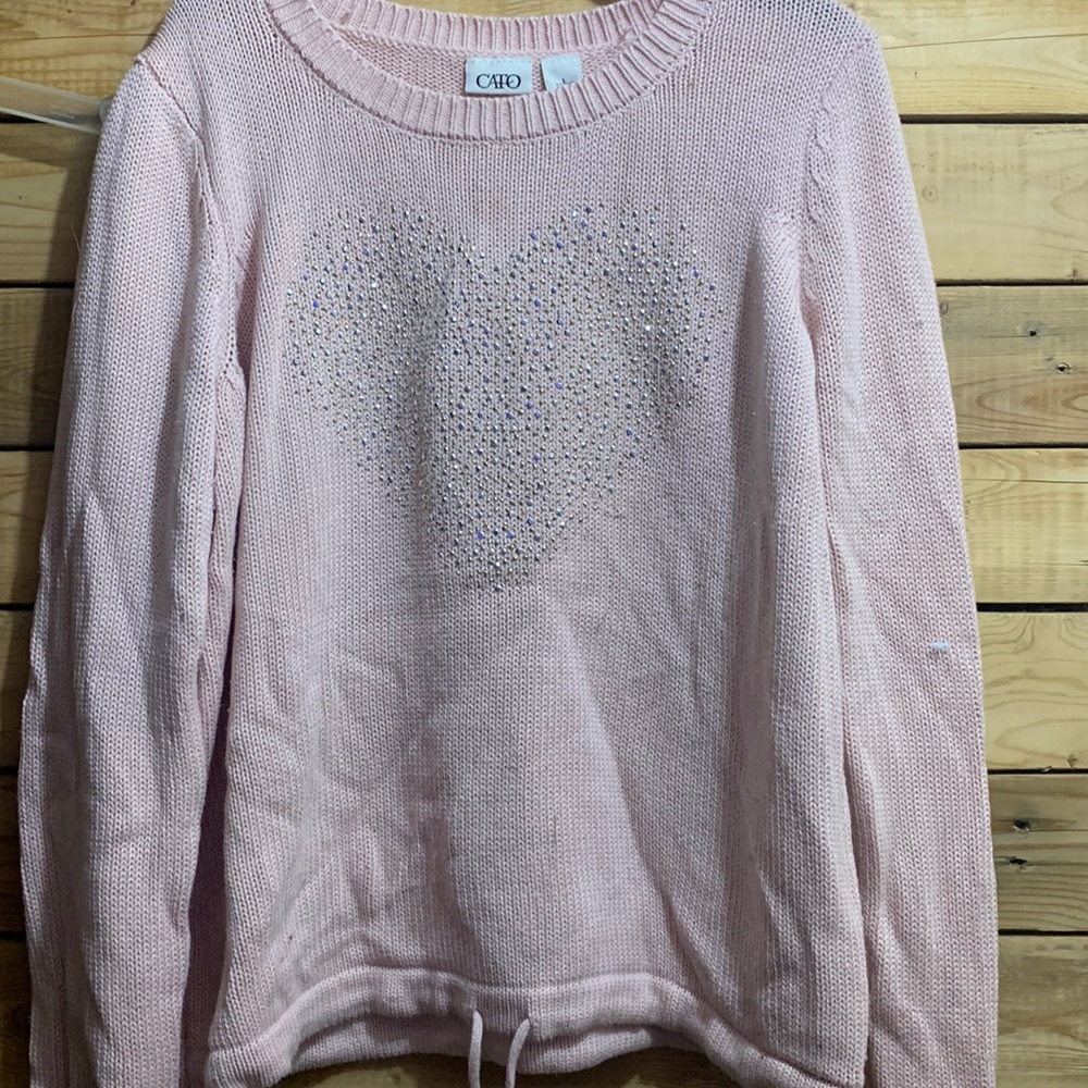 pink sweater has a heart on it